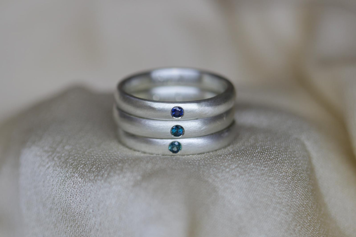 Brushed silver band with sapphire
