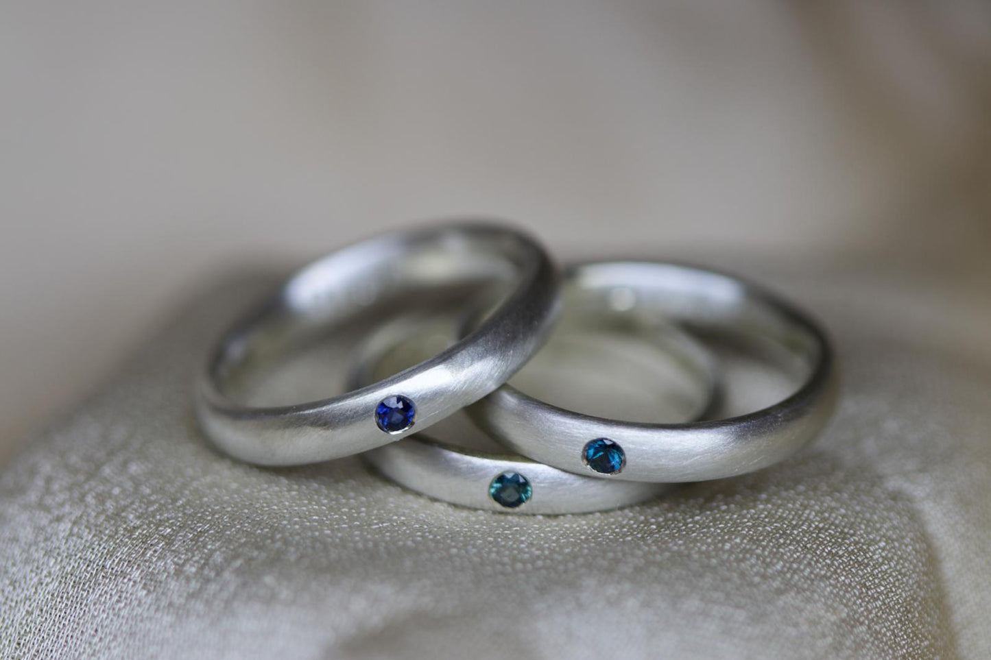 Brushed silver band with sapphire